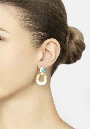 Gold earrings with a white enamel and turquoise accent. The design features an oval shape with curved elements and textured detailing.