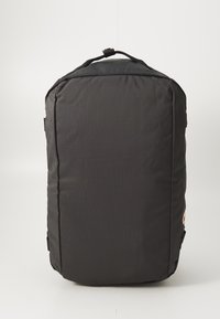 Black backpack with a rectangular shape, made of textured fabric, featuring a top handle and visible stitching details.
