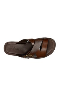 Brown leather slide sandal with textured crisscross straps and a metal buckle. Cushioned footbed and smooth sole for comfort.