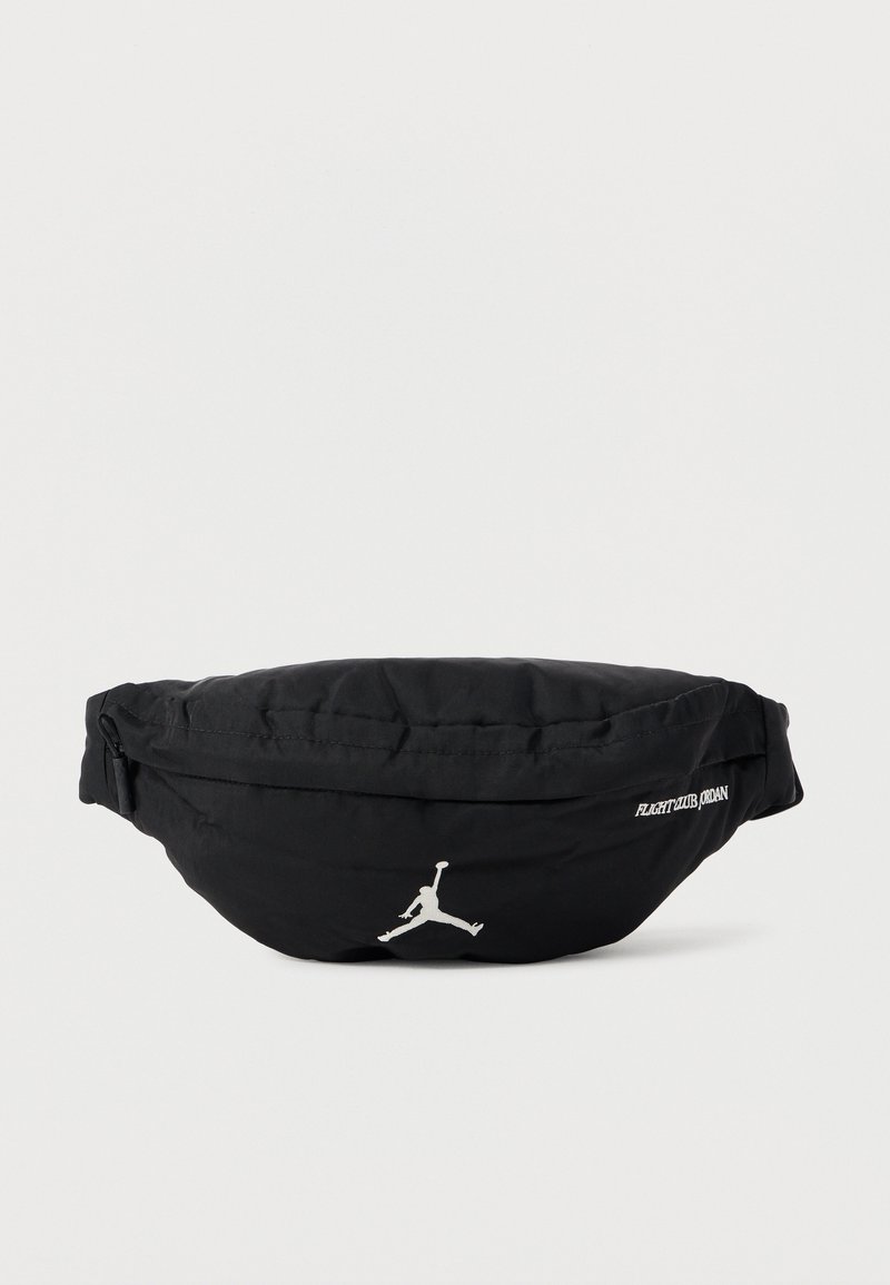 Musta nailoninen vyölaukku pyöreällä muotoilulla, jossa on hopeinen Jumpman-logo ja "FLIGHT CLUB JORDAN" -teksti sivulla. Vetoketjullinen suljenta.