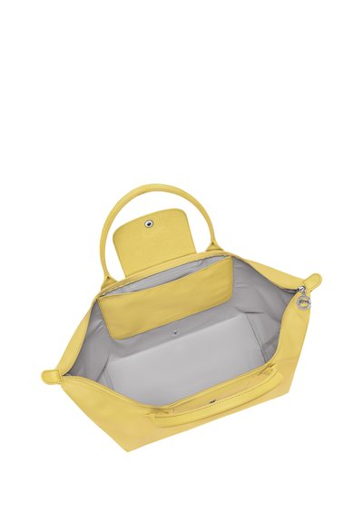 Yellow open handbag with rounded handles, a snap button flap pocket inside, and a zipper closure on top.