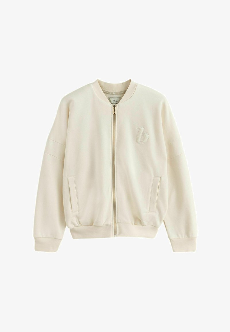 Giubbotto bomber beige crema con zip, con polsini e orlo a coste, due tasche frontali e un logo ricamato sul petto sinistro.