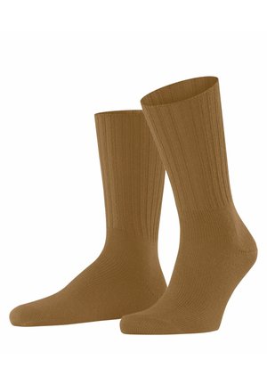 Braune gerippte Socken mit einem Design bis zur Mitte der Wade, das eine glatte Textur und subtile Nähdetails in der Nähe der Zehen aufweist.