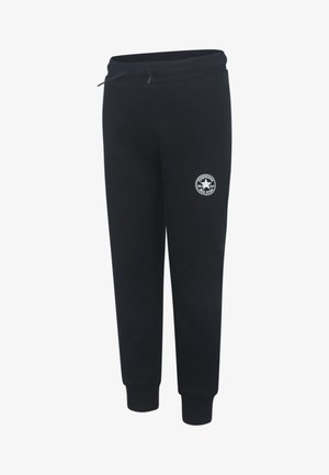 Black sweatpants with an elastic waistband, drawstring, and ribbed cuffs. Features a round white logo patch on the left thigh.