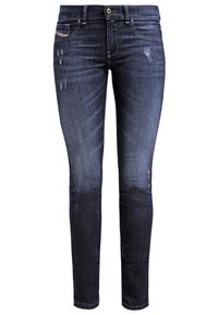 Jeans in denim blu scuro con vestibilità skinny, caratterizzati da dettagli strappati e una vita media. Design classico a cinque tasche con bottone in metallo.