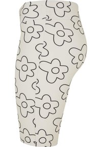 White leggings featuring black outlined floral patterns, with a fitted design and smooth texture, extending to mid-thigh length.