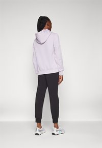 Champion ICONS CUFF PANTS LARGE LOGO - Tréningruha alsók - black