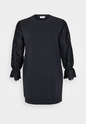 Black sweatshirt dress with round neckline, featuring long black lace sleeves with scalloped edges and floral patterns. Soft cotton blend fabric.