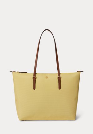 Kollane kandekott pruunide nahast sangade ja kuldse tõmblukuga, esiküljel keskel väike kuldne RL logo.