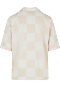 Chemise à manches courtes en beige clair avec un motif à carreaux. Tissu doux, coupe décontractée, dotée d'un col classique et de manches retroussées.