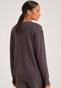 Langsleeve, donkergrijze top met een relaxte fit, ronde halslijn en geribbelde accenten bij de manchetten en de zoom, gemaakt van een zachte, lichte stof.