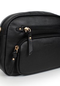 Borsa in pelle nera con due scomparti con zip, dettagli in metallo dorato e una texture liscia. Presenta spallacci regolabili e logo impresso.