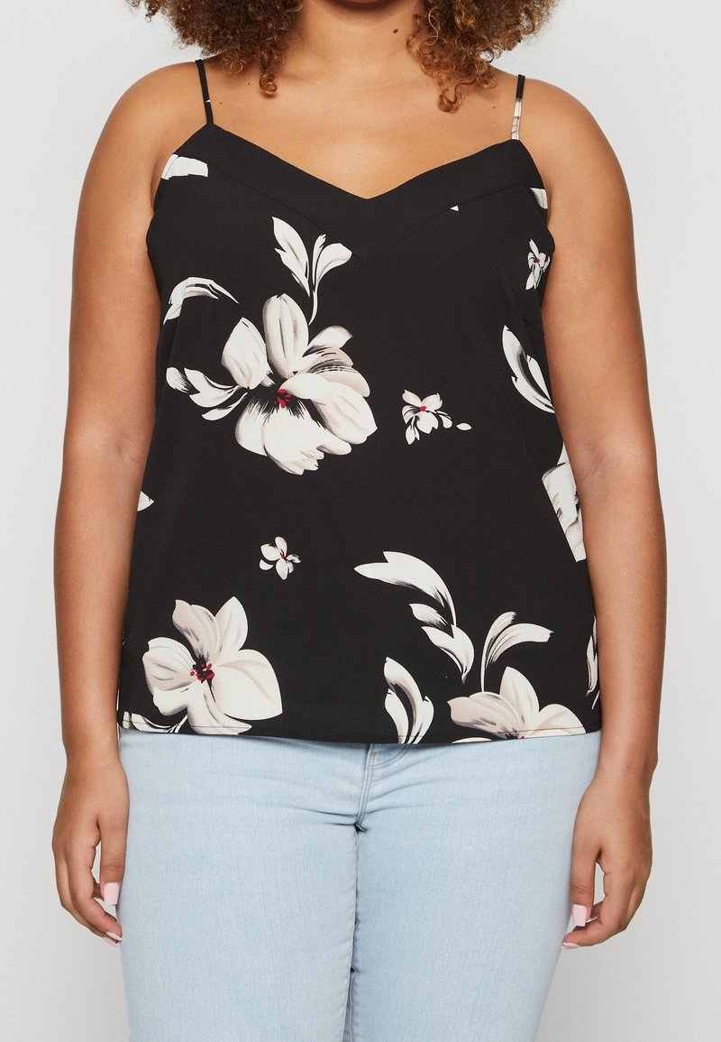 Svart blommig cami med vita och röda blomster mönster, v-ringning och tunna justerbara band, tillverkad av ett lätt tyg.