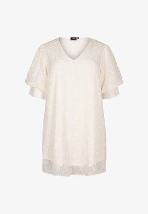 Vit spets tunika med V-hals, korta ärmar och blommönster. Har en något utställd silhuett och subtila skimrande detaljer.