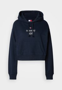 Felpa corta blu navy in morbido cotone. Presenta una tasca frontale, cappuccio con coulisse e ricamo "tommy girl" con un accento di stella rossa.