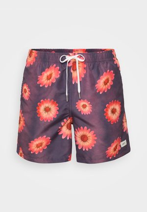 Svømmebukser med en lilla bakgrunn som har et blomsterprint av store rosa tusenfryd. Justerbar hvit snor i livet, lett materiale.