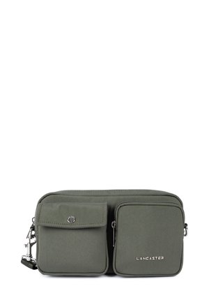 Borsa a tracolla verde in tessuto con due tasche frontali, hardware argentato e chiusura con zip. Presenta un logo impresso sul davanti.