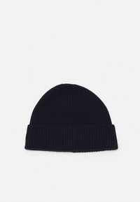 Pīta beanie tumši zila krāsā ar teksturētu ribu rakstu un plašu apmali. Mīksts audums ar noapaļotu augšu.