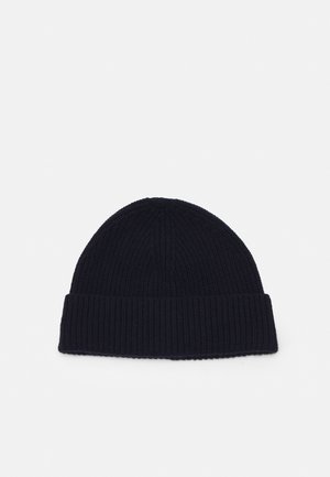 Neulottu pipo tummansinisellä värillä, jossa on tekstuurinen ribbikuvio ja leveä resori. Pehmeä kangas ja pyöreä huippu.