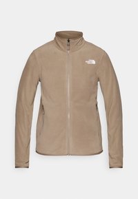 Beež täispikkuseline fliiskostüüm, millel on seisukrae, kaks lukuga külgtaskut ja valge "The North Face" logo vasakul rinnal.
