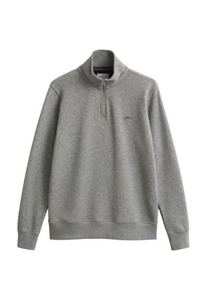 Jersey de manga larga de color gris claro con cuello con cremallera hasta un cuarto y pequeño logo bordado en el pecho izquierdo.