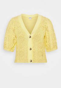 Gul croppad cardigan med V-ringning, korta puffärmar och ett intrikat mönster av spetsstickning. Har en knappstängning framtill i mitten.