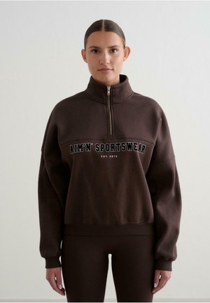Brown pullover sweatshirt with a high collar and half-zipper. Features bold white text "AIM'N SPORTSWEAR EST. 2013" on the front.