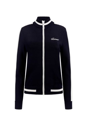 Veste zippée navy avec col montant, accents blancs sur les manches et l'ourlet, poignets côtelés et détails de logo sur le devant. Fabriquée en matière tricotée.