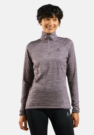 Light purple athletic long-sleeve shirt with a quarter-zip neck. Features a subtle striped pattern and logo on the left chest. Stretch fabric.