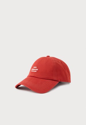 Red cotton baseball cap with a curved visor, featuring white embroidered text and metal eyelets for ventilation.