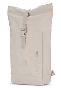 Roll-top backpack in light beige fabric with a textured finish. Features adjustable strap, side zip pocket, and logo patch on the front.