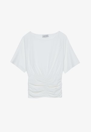 Valkoinen lyhythihainen paita, jossa on rento istuvuus, ja vyötäröllä on poimittu rypytysdesign sekä sileä kangas. Merkki: Anna Field.