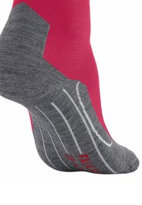 Calzini sportivi grigi e rosa con una soletta testurizzata, tallone rinforzato e strisce bianche per una maggiore aderenza e supporto.