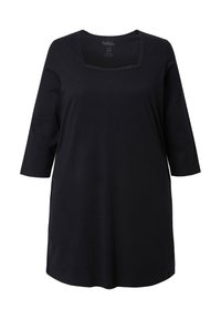 Musta tunika, jossa on kolme neljäsosahihat, neliömäinen pääntie, pehmeästä kankaasta, rento istuvuus ja hillityt yksityiskohdat.