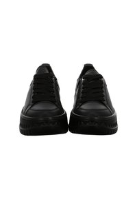 Pair of black leather sneakers with thick textured soles, black laces, and side zippers, shown from the front on a white background.