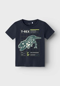 Navy T-Shirt mit Grafik eines Dinosaurierskeletts. Hellgrüner Text enthält Informationen über T-Rex. Rundhalsausschnitt, kurze Ärmel, Baumwollstoff.