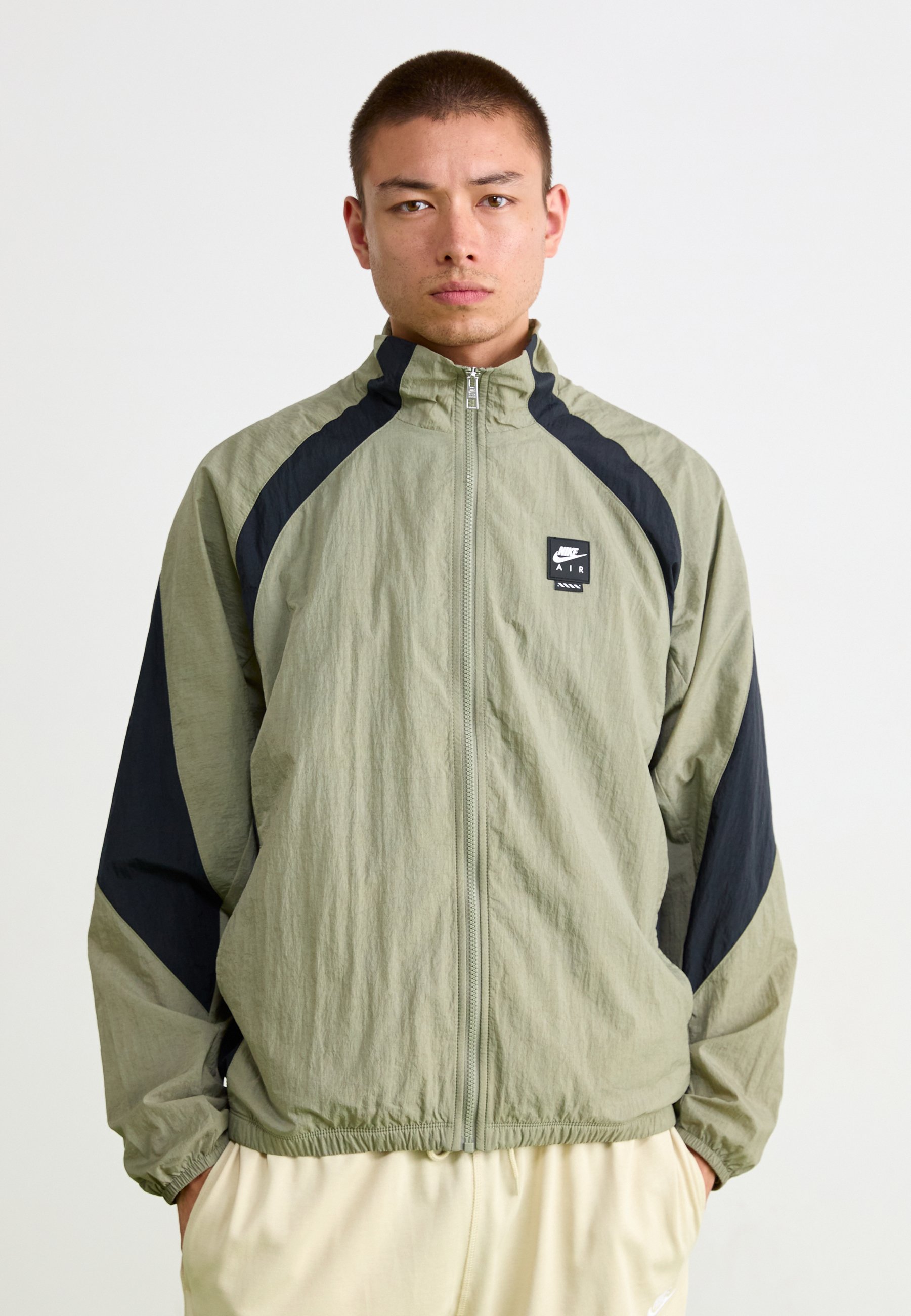 olive green and white nike windbreaker