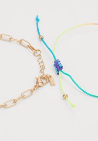 Gold chain bracelet with a lobster clasp; includes a colorful woven friendship bracelet in blue, green, and purple with adjustable ends.