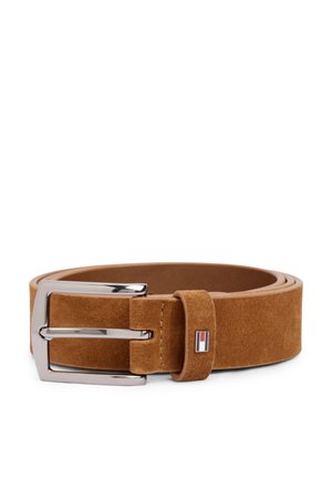 Ceinture en daim marron roulée avec une boucle métallique argentée et une petite étiquette rectangulaire avec logo sur la boucle de la ceinture.