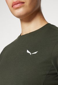 Ελαιόχρωμο ριγέ αθλητικό t-shirt με λευκό λογότυπο στο πάνω αριστερό μέρος του στήθους, κλασικό στρογγυλό λαιμό και μαλακή υφή.
