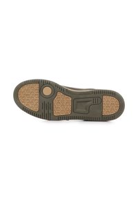 Suola della scarpa con una base in gomma di colore verde scuro, superficie di aderenza a motivo esagonale di colore beige e un accento circolare in gomma.