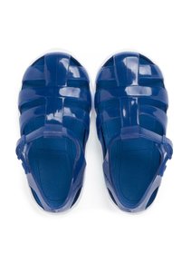 Blue plastic sandals with a woven design, featuring an adjustable strap. The textured footbed provides grip and comfort.