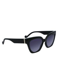 Occhiali da sole neri a forma di occhi di gatto con lenti sfumate, aste nere testurizzate e un accento dorato sulle tempie. Design della montatura in plastica liscia.