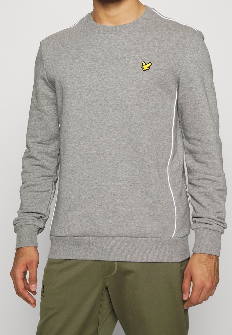 Gray sweatshirt made of cotton blend, featuring a round neckline, long sleeves, white accent piping, and a small yellow embroidered logo.