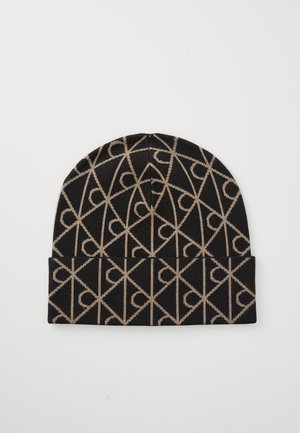 Knit beanie in black and tan featuring a geometric pattern. Soft texture with a fold-over cuff. Durable construction for warmth.