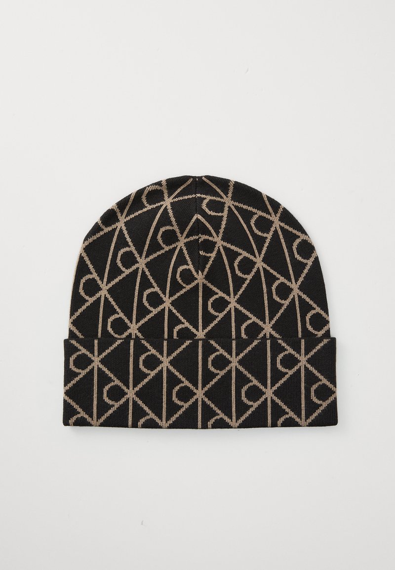 Bonnet en tricot noir et beige avec un motif géométrique. Texture douce avec un revers. Construction durable pour la chaleur.