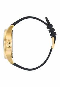 Zelta tonis pulkstenis ar taisnstūra seju, melnu gumijas siksnu un zelta akcentu sānos. Gluda virsma un minimālisma dizains.