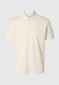 Polo tričko v barvě off-white vyrobené z bavlny, s krátkými rukávy, tříknoflíkovým zapínáním a texturovaným vzorem po celém povrchu.