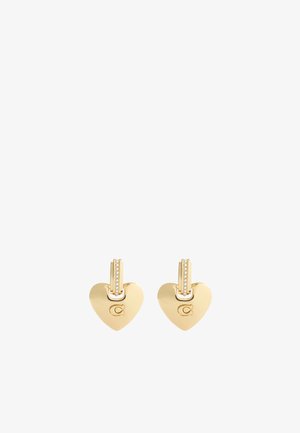 Boucles d'oreilles en or en forme de cœur avec un petit fermoir articulé accentué et un motif en haut. Présente un logo gravé sur un côté.