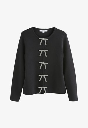 Zwarte gebreide trui met een ronde hals en rijen decoratieve strikken in een contrasterend patroon aan de voorkant.